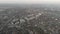 Aerial fly over city. Aerial camera bird eye view. Thick fog covered all fields