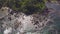 Aerial fly over a rocky coastal beach tropical island bay.