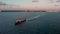 A aerial fly-by of a passenger and car ferry that goes between Isla Mujeres and Cancun in Mexico at sunrise.