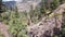 Aerial fly up from base of river to view of small mountain town Ouray, Colorado