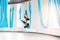 Aerial fly yoga in white gym, young gymnastics women in blue hammock