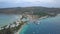 AERIAL: Flying above busy tropical island port filled with boats and ferries.