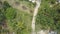 AERIAL: Flying above a female tourist riding her scooter through remote village.