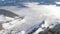 AERIAL: Flying above the idyllic snowy countryside in Bohinj wrapped in fog.