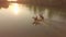 AERIAL Flying above two active women riding their horses down the tranquil river