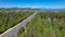 AERIAL: Flying along a wide highway leading towards the outskirts of Ljubljana.