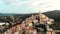 Aerial: flying around Cervo medieval town on the mediterranean coast, Liguria riviera, Italy, with the beautiful baroque church an