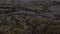 Aerial flying close over moss covered lava rocks in Iceland