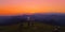 AERIAL: Flying in front of mountain bikers pedalling their bikes uphill at night