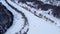 Aerial flying high on frozen wintery river in snow