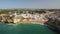 Aerial. Flying over the beach and the tourist village of Carvoeiro.