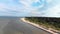 Aerial flying over beautiful white paradise sand beach in Latvia and the Baltic Sea Gulf