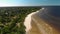 Aerial flying over beautiful white paradise sand beach in Latvia and the Baltic Sea Gulf