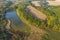 Aerial Flying over countryside with village, forest, ponds, and fields at autumn sunset time. Wonderful drone photo for ecological