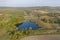 Aerial Flying over countryside with village, forest, ponds, and fields at autumn sunset time. Wonderful drone photo for ecological