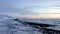 AERIAL: Flying over Diamond Beach, Black Beach in Iceland in Winter Snow, Ice, Waves, Water