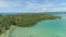AERIAL: Flying over lush tropical forest and breathtaking white sand beaches.