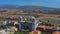 AERIAL : flying over luxury resorts, discovering wide tropical island with palms and mountains in the distance.