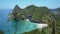 AERIAL: Flying past tranquil palm trees reveals a breathtaking tropical beach.