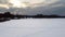 Aerial flying up on frozen wintery river in snow