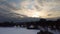 Aerial flying up on frozen wintery river in snow