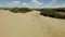 Aerial flyover of a man walking on a dry African river bed, dry season