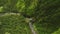 Aerial flyover of river running through mountain valley