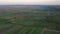 Aerial footage of an agricultural area and green rolling fields.