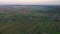 Aerial footage of an agricultural area and green rolling fields.