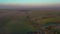 Aerial footage of an agricultural area and green rolling fields.