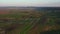 Aerial footage of an agricultural area and green rolling fields.