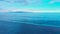 Aerial footage of awesome ocean with blue water, wonderful colorful sky and island on Bali 4K