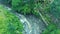 Aerial footage of the beautiful waterfall with foaming water, great rocks and green plants on Bali Indonesia 4k travel world