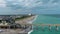 aerial footage of the blue ocean water along the coastline at Johnnie Mercer\\\'s Fishing Pier with homes, people on the sand