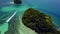 Aerial footage of a boat going through two small islands,