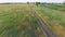 Aerial footage of boy riding bike. Countryside road. Agricultural field in summer. Ukrainian nature