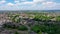 Aerial footage of the British village of Pudsey in Leeds showing typical housing estates with a church in the background and white