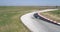 Aerial footage of car racing track with corners championship driving cinematic look asphalt burned tires  cloudy day high speed co