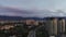 Aerial footage of colourful sunset with clouds over the Almaty city near the mountain