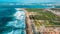 The Aerial footage of Costa da Caparica coastline of glorious sandy beaches, powerful Atlantic waves. Portugal