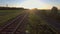 Aerial footage from a drone flying along a train track in a rural