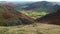 Aerial footage of female tourist enjoying the view of Great Langdale valley, UK