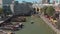 Aerial footage of a fly over of the harbor of Rotterdam, Netherlands where several boats and barges are docked.