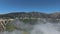 Aerial footage of forest-covered hills, blue skies and clouds on the slopes near Big Bear Lake, California, USA