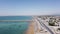 Aerial footage of Gwadar city and marine drive of the Arabian sea under a blue sky