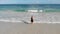 Aerial footage of hot girl walking out of the ocean to the white sand beach