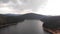 Aerial Footage of Large Lake  and mountains surrounded by Forest