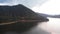 Aerial Footage of Large Lake  and mountains surrounded by Forest