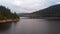 Aerial Footage of Large Lake  and mountains surrounded by Forest