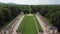 Aerial footage of a massive german palace with green lawn at the back, 4k